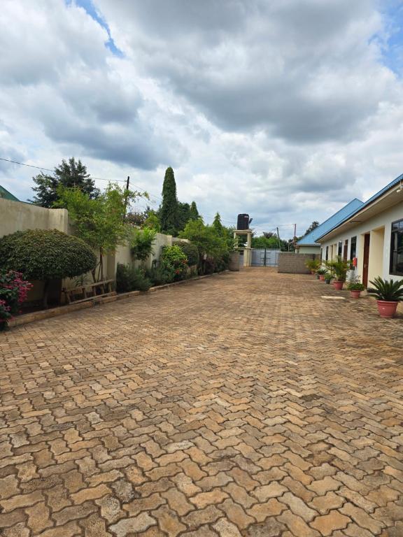 a brick driveway in front of a house at Kilimanjaro Magic MJ Branch in Old Moshi