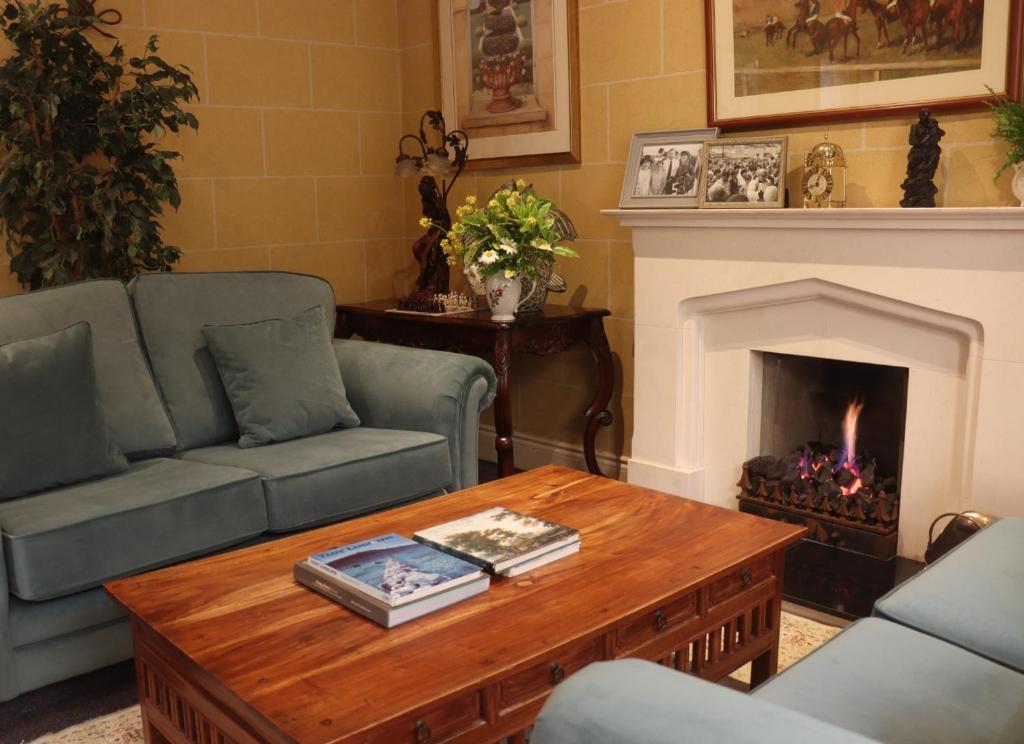 a living room with a couch and a fireplace at White Sands Hotel in Ballyheigue