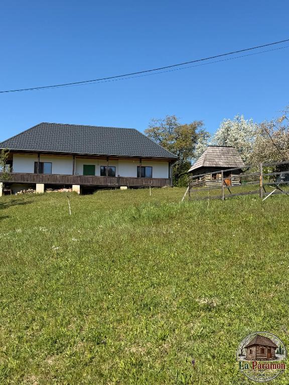 a house in a field of grass with a house at La Paramon ! in Sângeorz-Băi