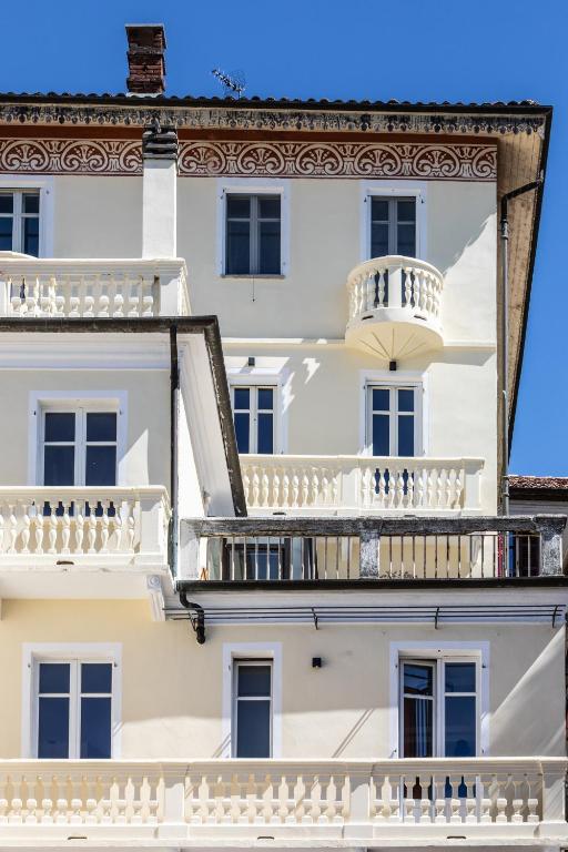 a building with white balconies and a balcony at Moleloca - Casa Bacolla in Cocconato