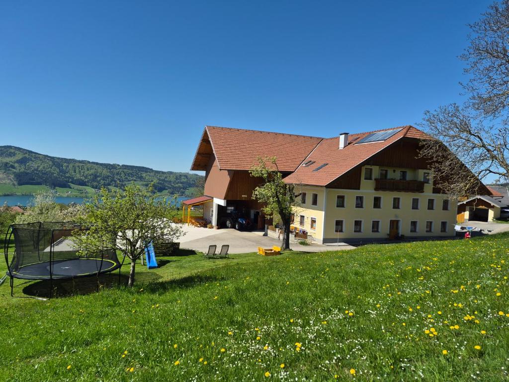 a large building on top of a green field at Ferienhof Edtmeier in Zell am Moos