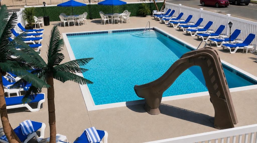 an empty swimming pool with a water slide at Beach Colony Motel in Wildwood Crest