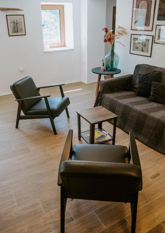 a living room with a couch and a chair at Hiša Potoki in Kobarid