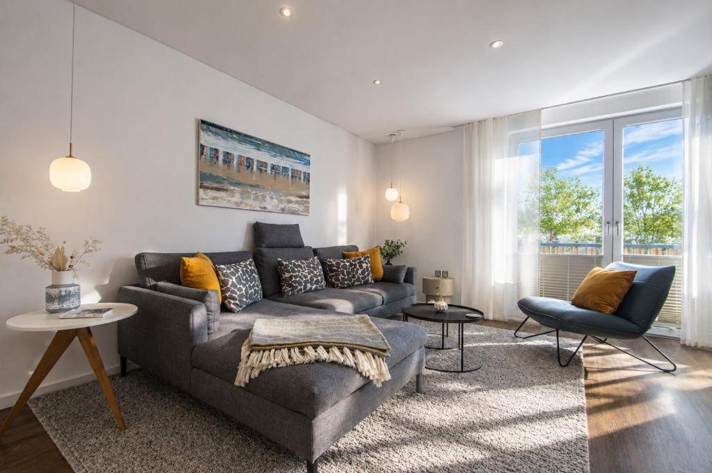 a living room with a couch and a chair at Wohnart - Fewo 1 Wohnstil in Norderney