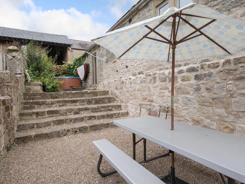 a white table with an umbrella and a bench at Cokaynes -Rxx9 in Stanton in Peak