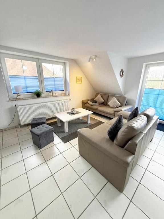 a living room with a couch and a table at Strandgut in Fehmarn