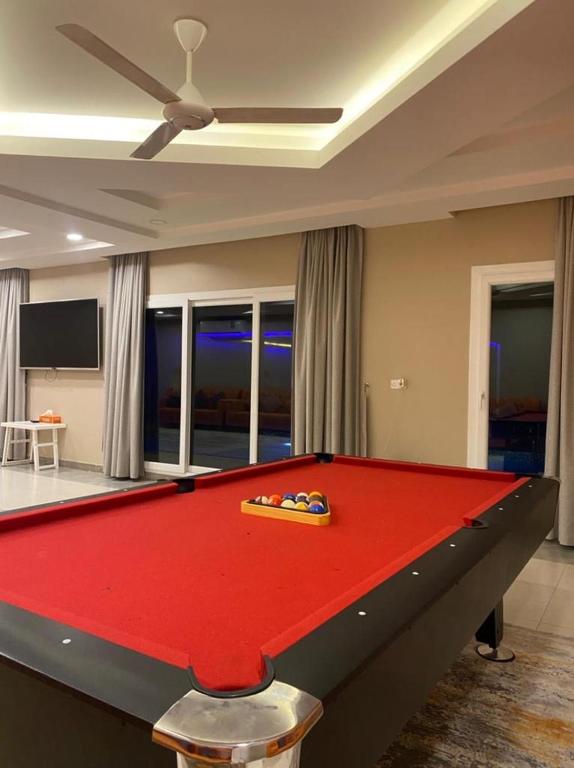a red pool table in a living room at Rovana Chalet in Barka