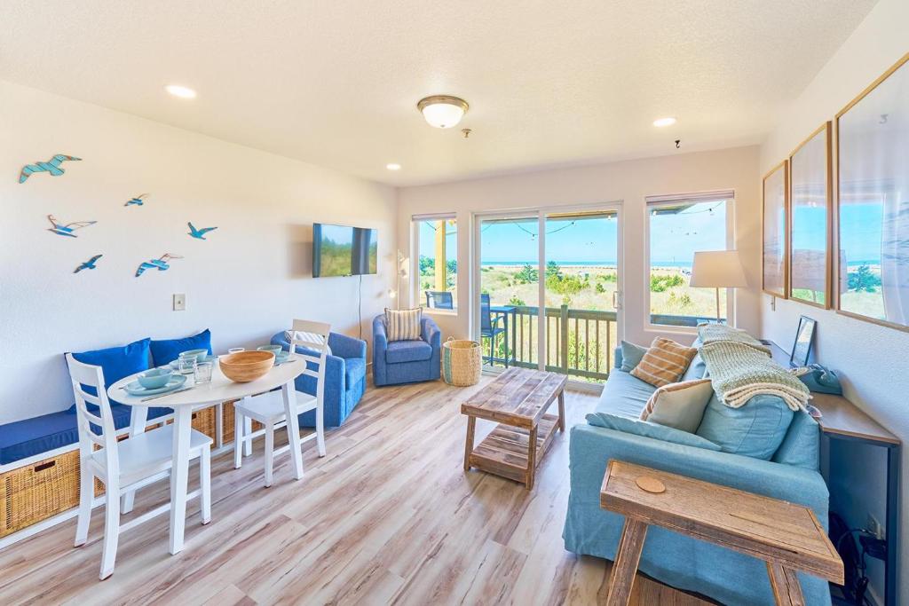 a living room with a blue couch and a table at Saltwater & Sunsets in Long Beach
