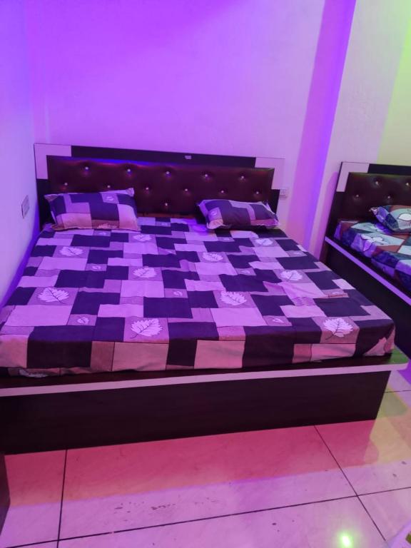 a bedroom with a bed with a chess board on it at New MORVINAND PALACE in Khātu