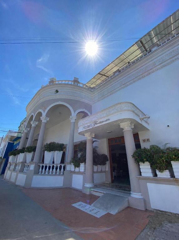 a large white building with the sun in the sky at Fontamar 43 in Barranquilla
