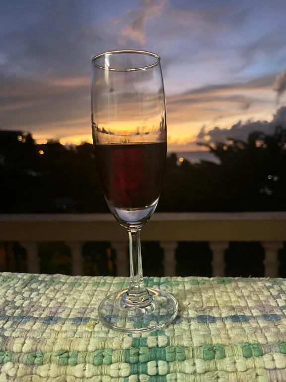 a glass of wine sitting on top of a table at CJ's Creole Hideaway in Castries