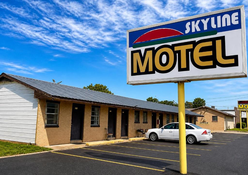 a sign in a parking lot in front of a motel at Skyline Motel Bartlesville Hwy 75 in Bartlesville