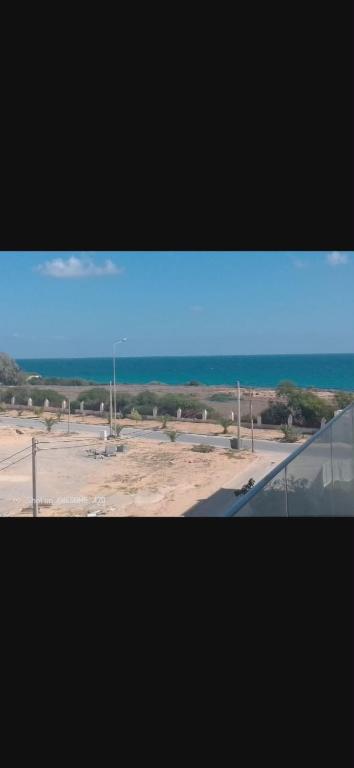 a view from a window of a parking lot at Appartement Hergla in Harqalah