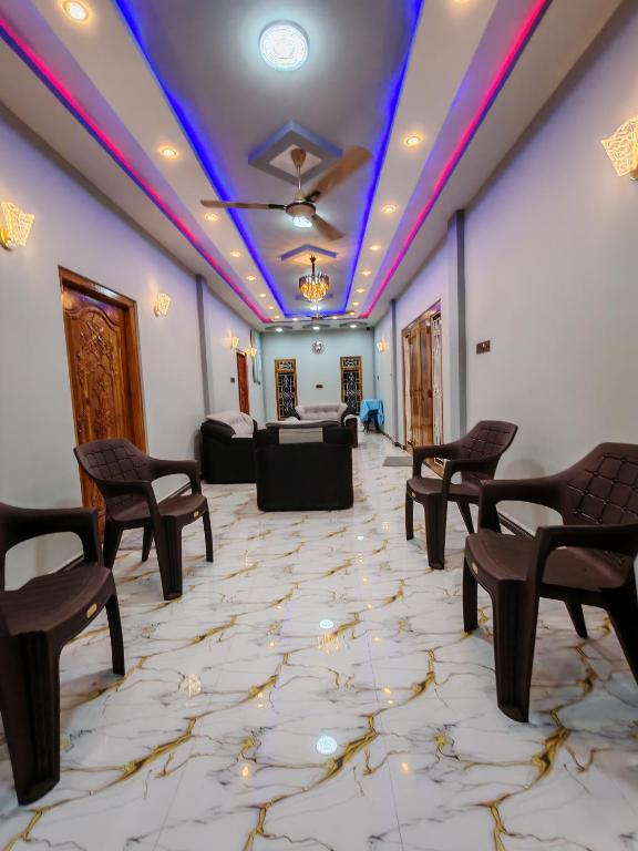a room with chairs and a table in the background at VIN Solara Farm Stay in Jaffna