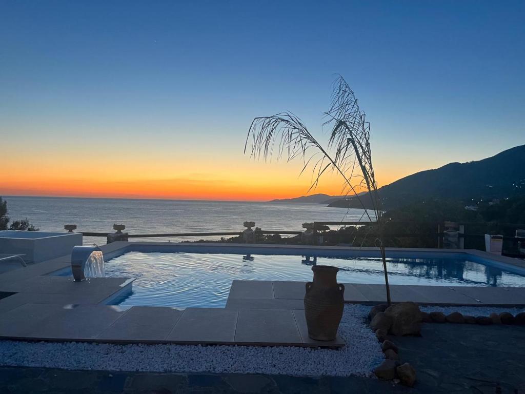 a swimming pool with a view of the ocean at sunset at Antica Dimora Palinuro in Palinuro
