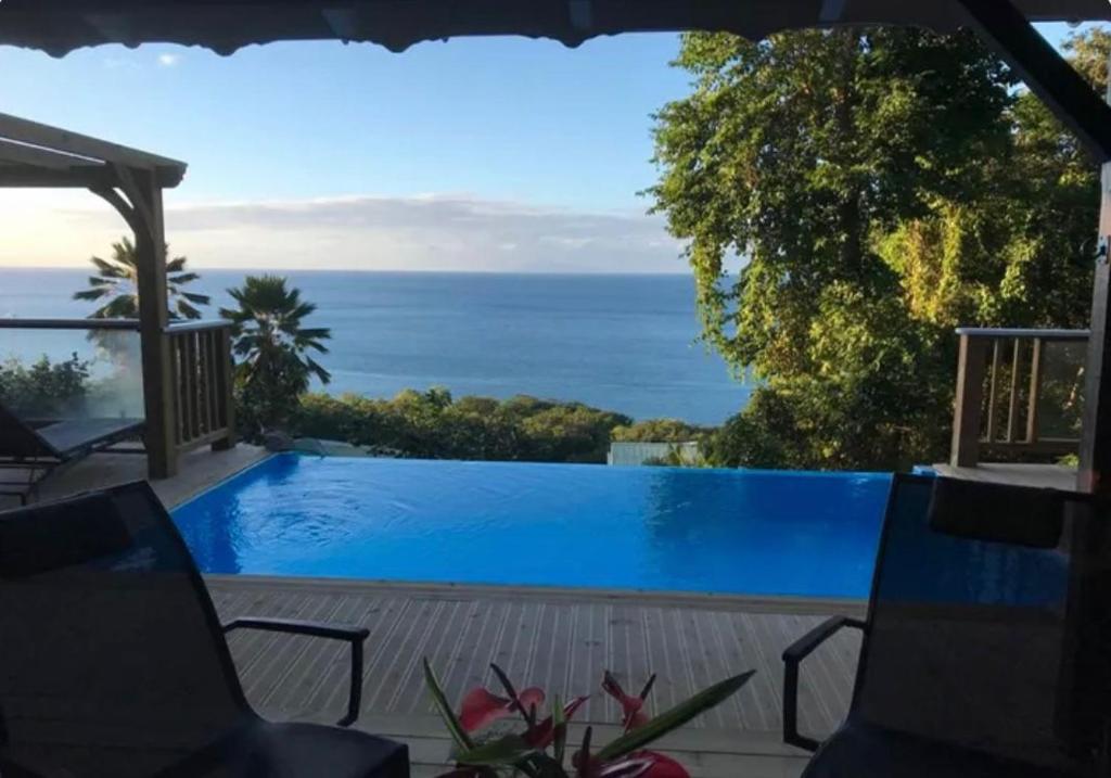 a swimming pool with a view of the ocean at Villa Vigie in Deshaies