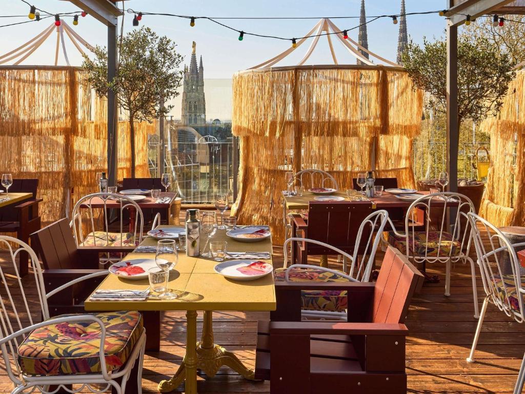 a restaurant with tables and chairs on a patio at Mama Shelter Bordeaux Centre in Bordeaux