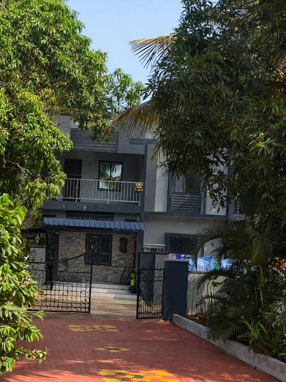 an apartment building with a balcony and a gate at Shyams homestay MV in Malpe