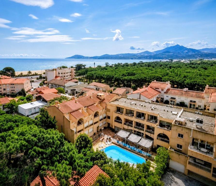 an aerial view of a city with a building and a pool at Hôtel Le Maritime in Argelès-sur-Mer