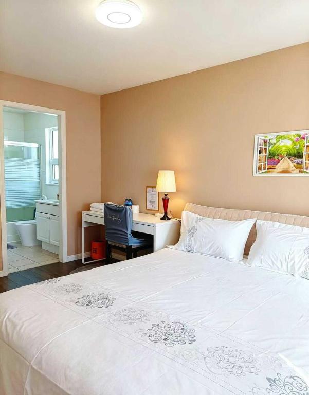 a bedroom with a bed and a desk with a computer at Cozy Home in Vancouver in Vancouver