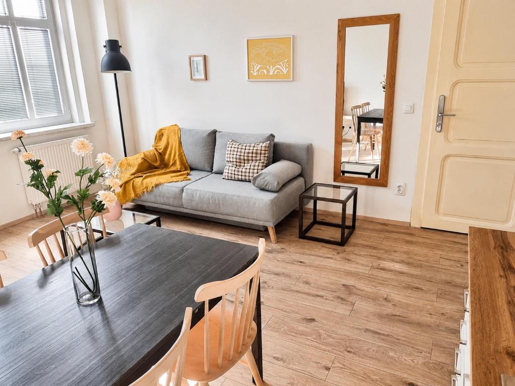 a living room with a table and a couch at Villa Medica in Kraslice