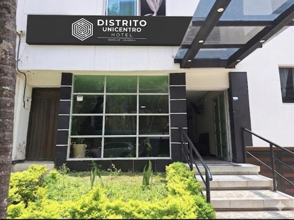 a building with a sign on the front of it at Hotel Distrito Unicentro in Medellín