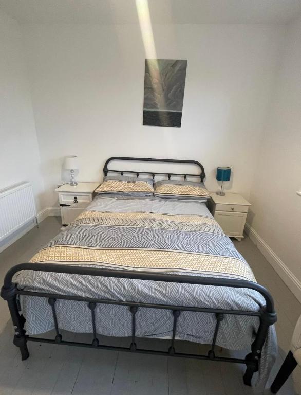 a bed in a room with two nightstands and a bed sidx sidx sidx at Wild Atlantic View in Walshestown
