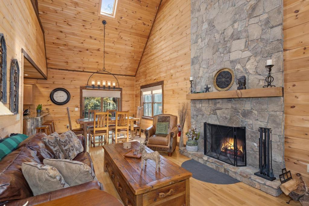 a living room with a stone fireplace in a house at 1 Kingfisher in Blowing Rock