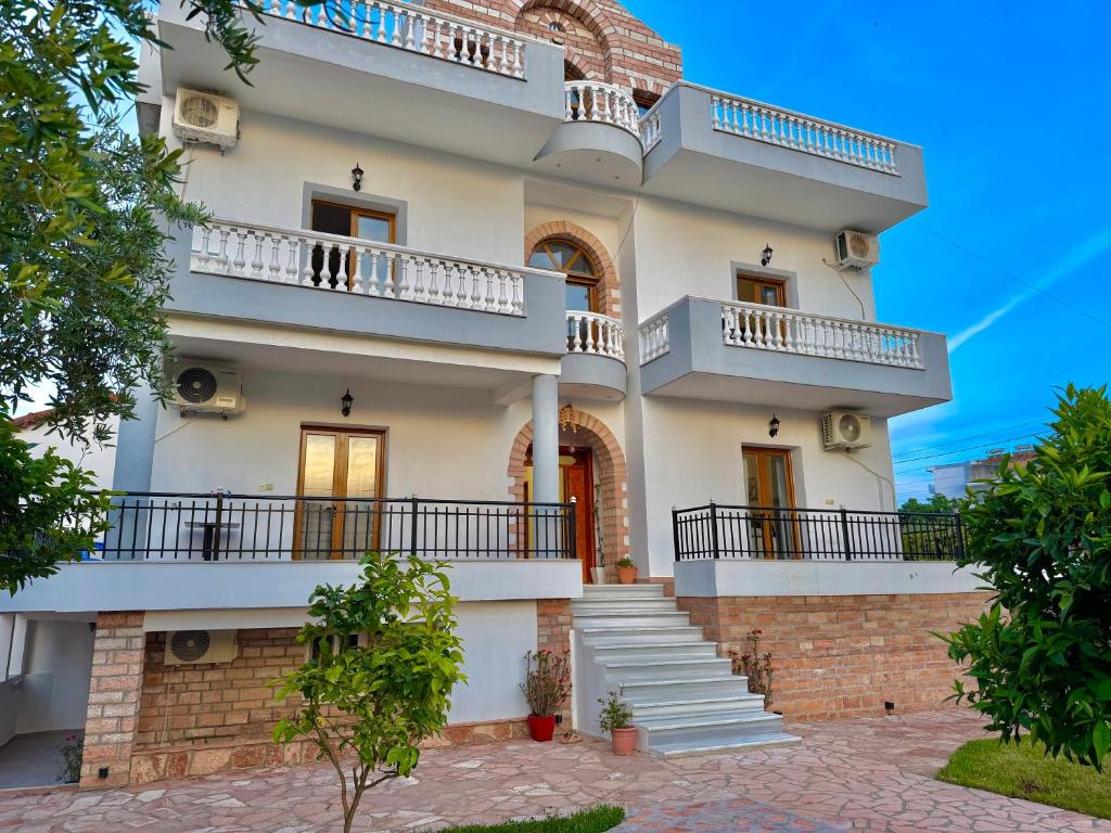 a large white building with balconies on it at Vila Sidi in Ksamil