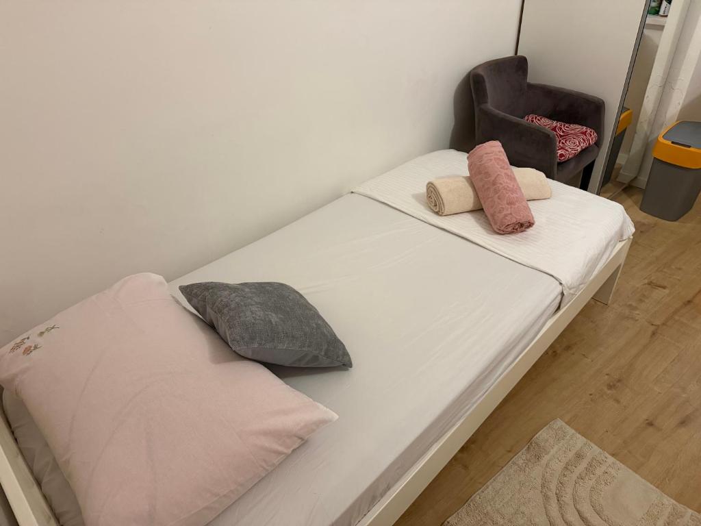a bed with two pillows on it in a room at Luxury rooms in Split