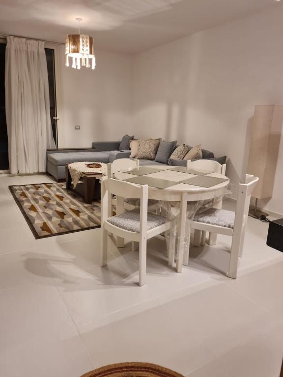 a living room with a table and a couch at Amazing lagoon view chalet 3 bedrooms in Marsa Matruh