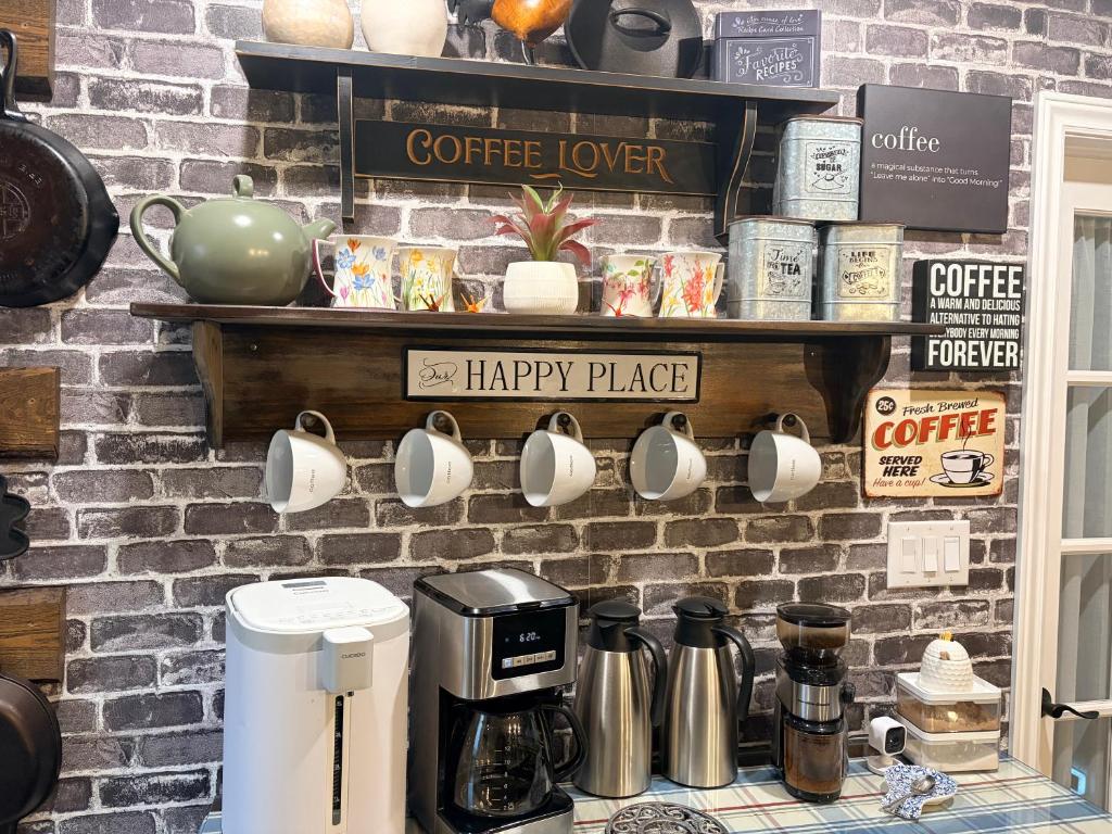 a counter with coffee cups on a brick wall at MonJardin Bed and Breakfast in Port Burwell