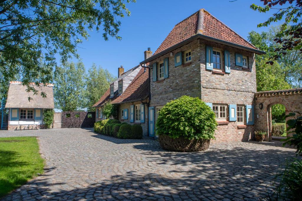 a large brick house with a brick driveway at Vakantiehuis Lisette in Veurne