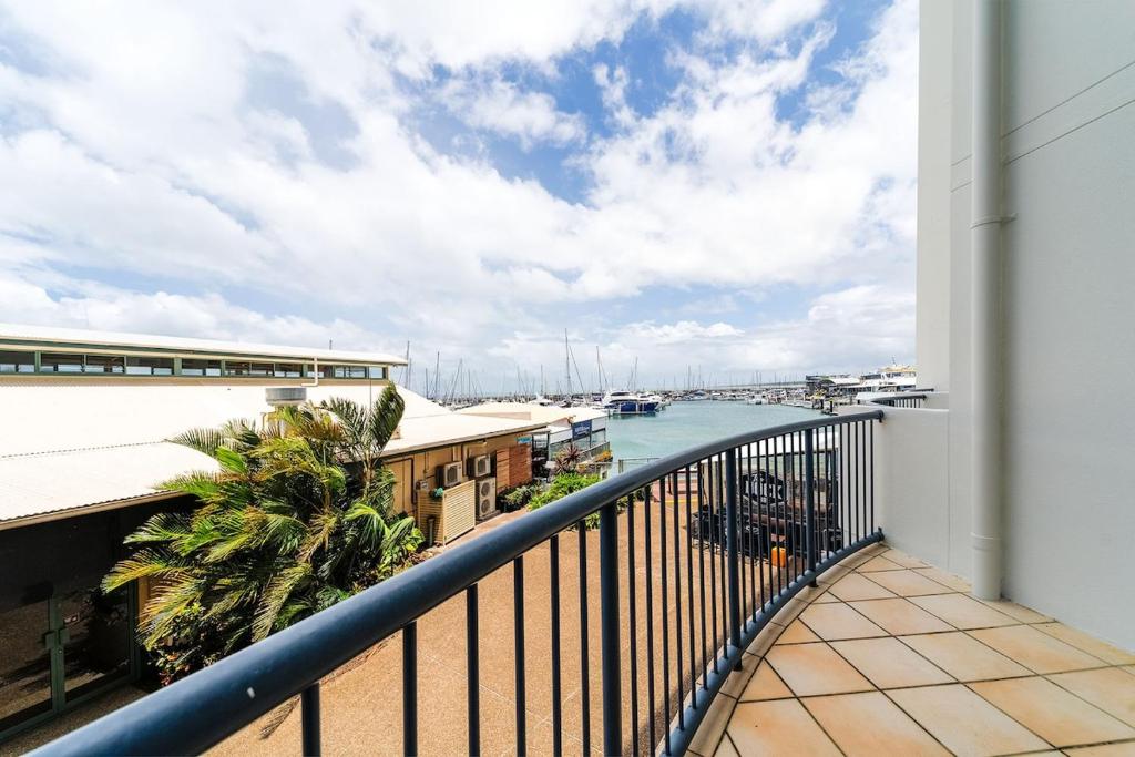 a balcony with a view of a body of water at 2nd Floor 1-Bedroom Apartment in Urangan