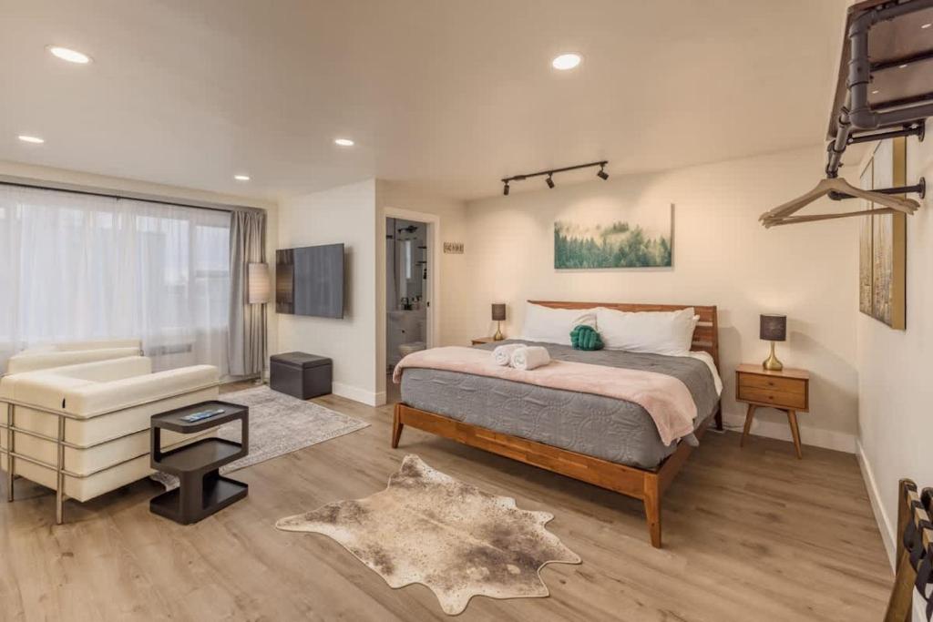a bedroom with a bed and a chair and a couch at Modern Studio Downtown Anchorage in Anchorage