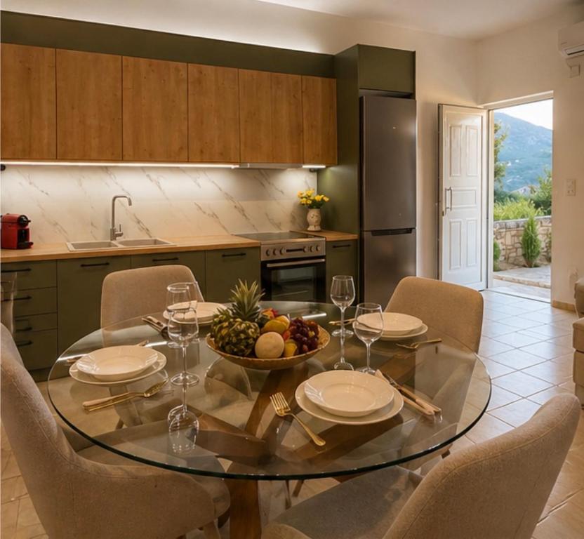 a kitchen with a table with a bowl of fruit on it at Archanes Cozy Retreat in Archanes