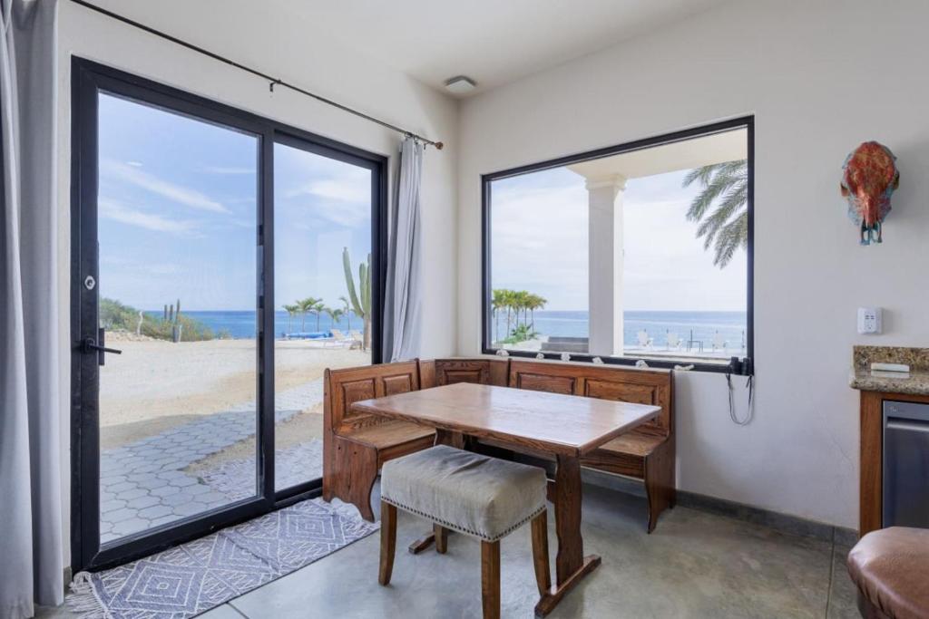 a dining room with a table and a view of the beach at Beachfront Pool, Rooftop Views & Baja Sunrise in Pescadero