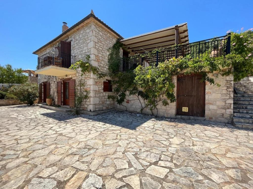 a house with a stone driveway in front of it at Villa Ionis in Volímai