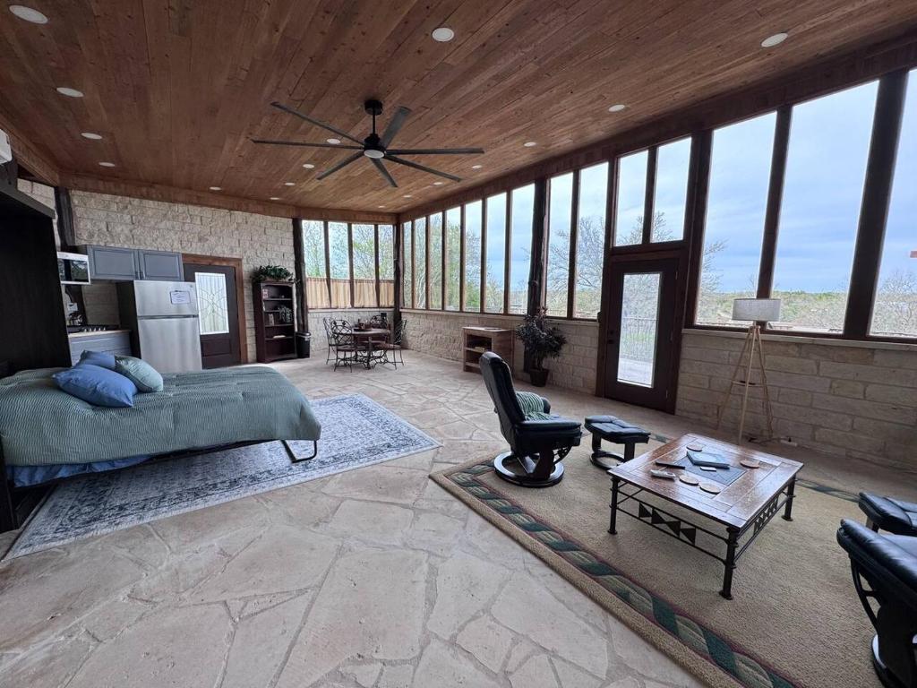 a bedroom with a bed and a ceiling fan at The Cross Patio Retreat in Buda