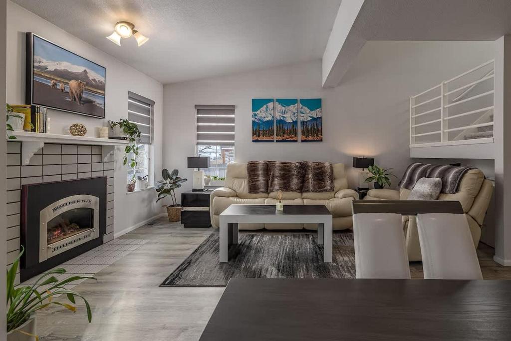 a living room with a couch and a fireplace at Charming Luxe Home Sleeps 4 in Anchorage