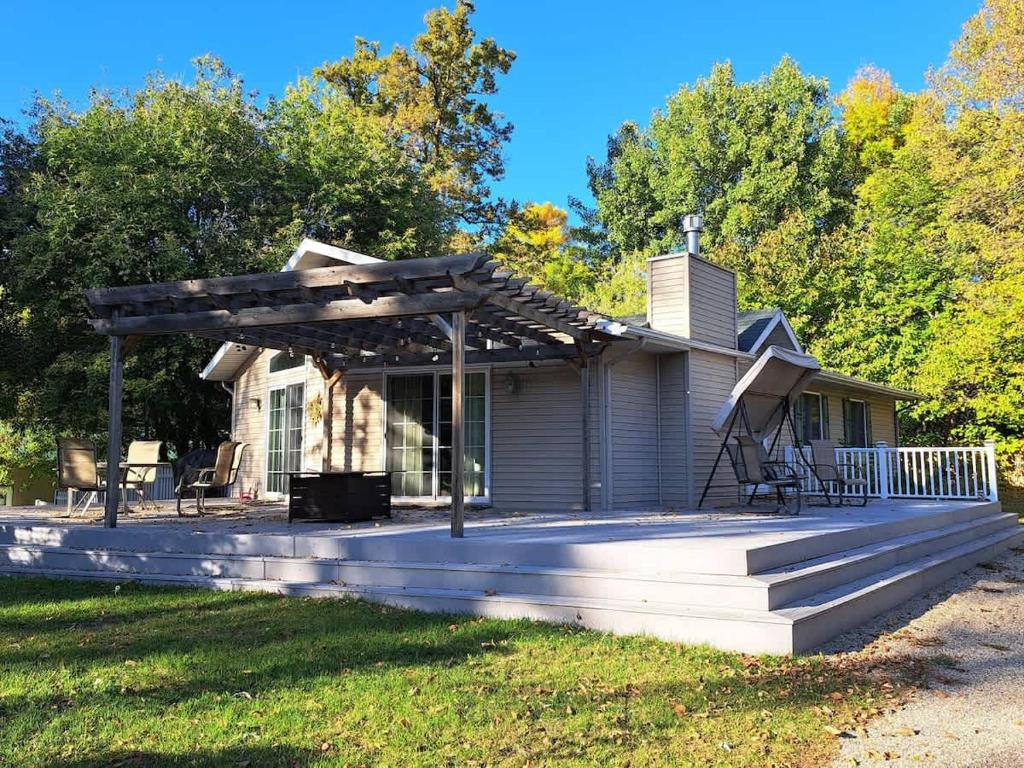 a house with a pergola on a deck at Lake Melissa Cabin on the Commons in Detroit Lakes