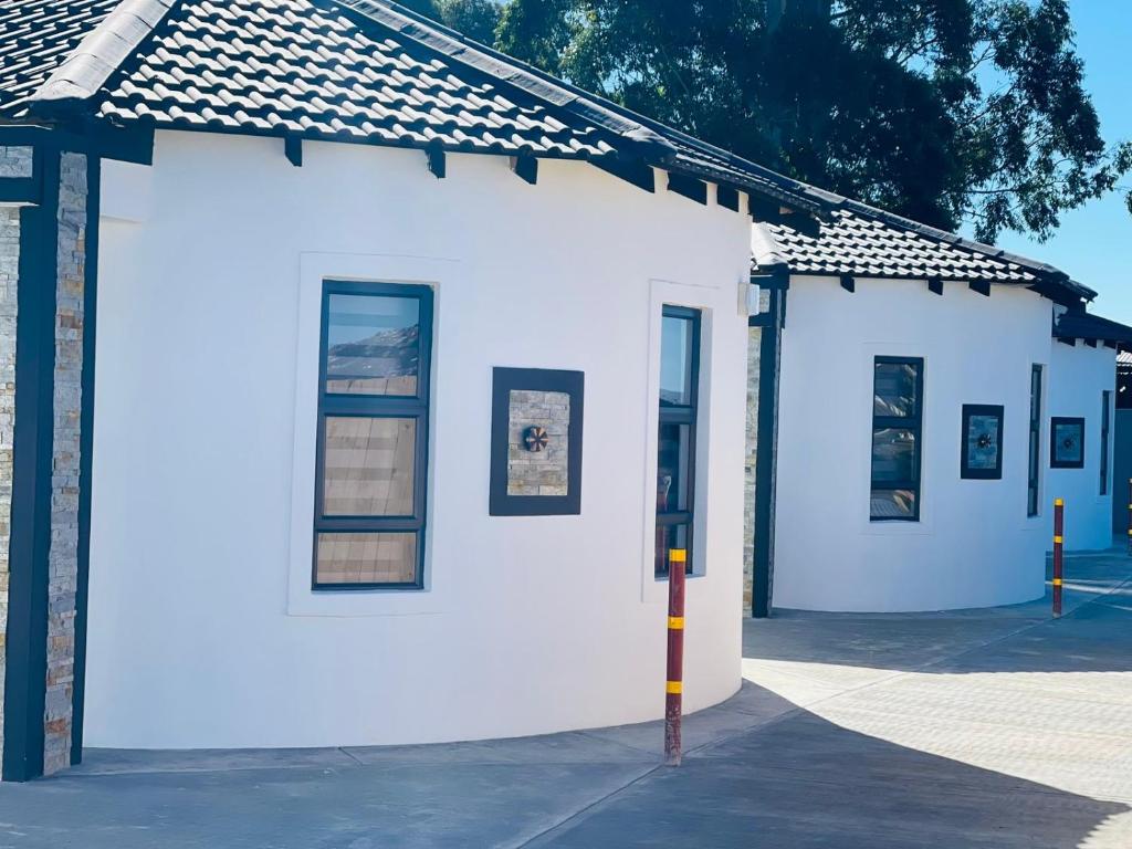 a white building with windows on the side of it at Lifestyle Villas in Sipilini
