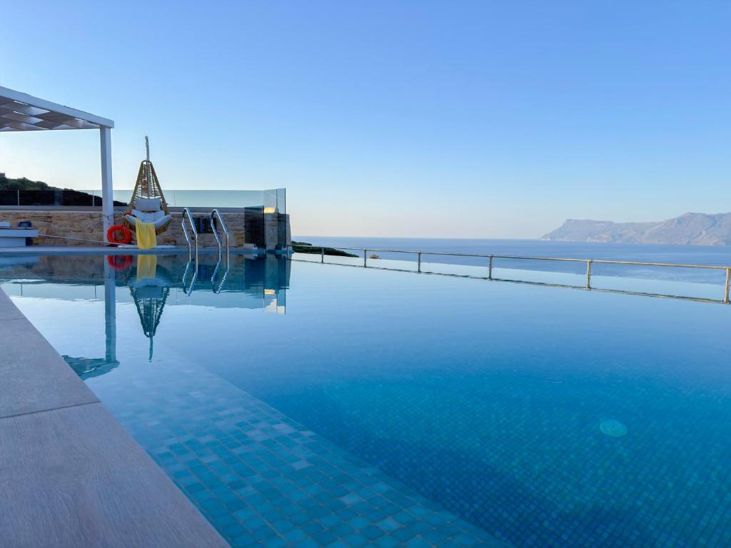 a swimming pool with a view of the ocean at Paleokastro Villas with Private Heated Pool, Top Views - Next To Center - Top WiFi in Kissamos