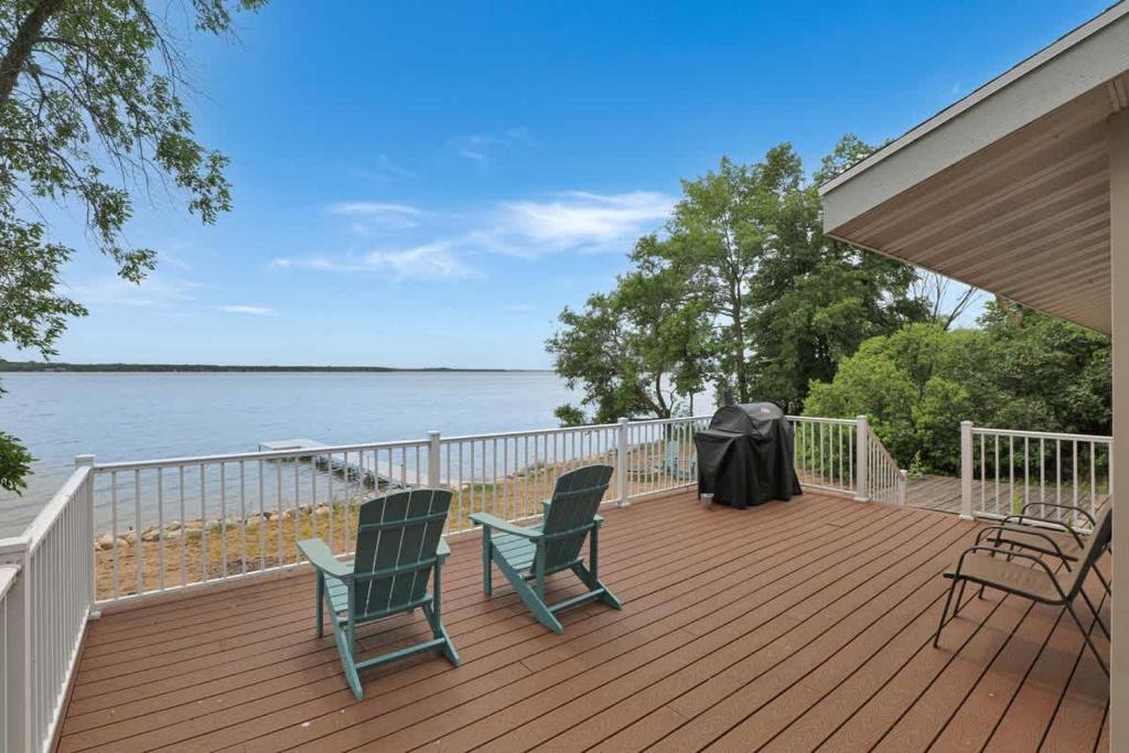 a wooden deck with two chairs and a table and chairs at Amazing Grace Etta Shores in Henning