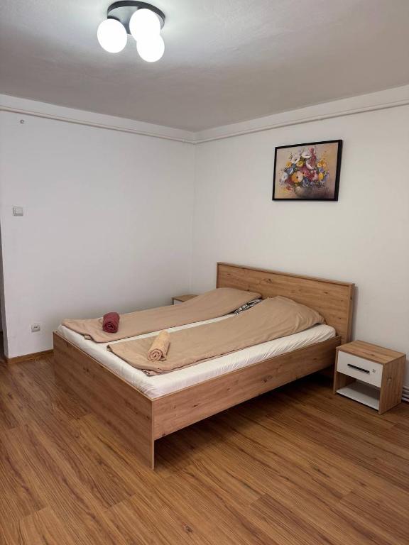 a bedroom with a wooden bed in a room at Hunyadi Nest in Hunedoara