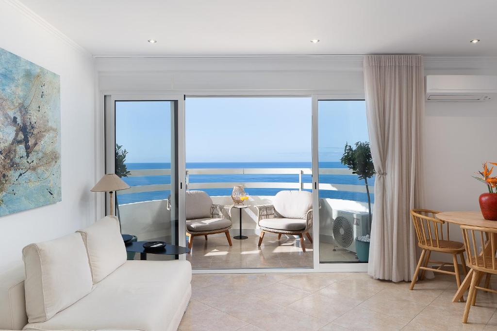 a living room with a view of the ocean at Lighthouse - Exclusive Sea view 180º, pool, parking in Portimão
