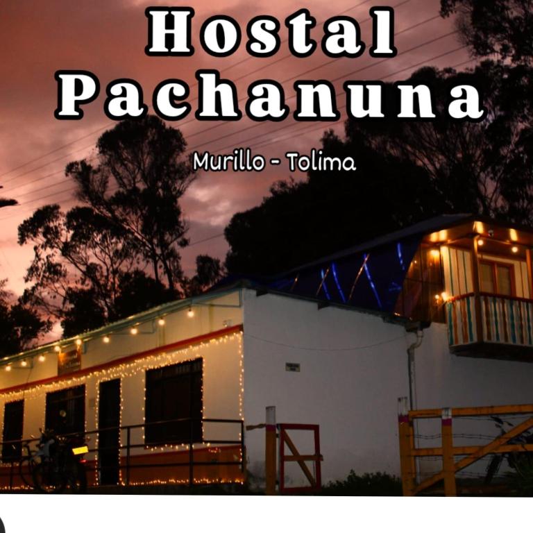 a house with christmas lights in front of it at Hostal Pachanuna in Murillo