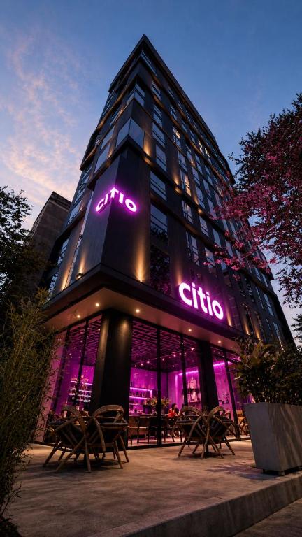 a building with a lit up sign on it at CITIO Hotel - Laureles in Medellín