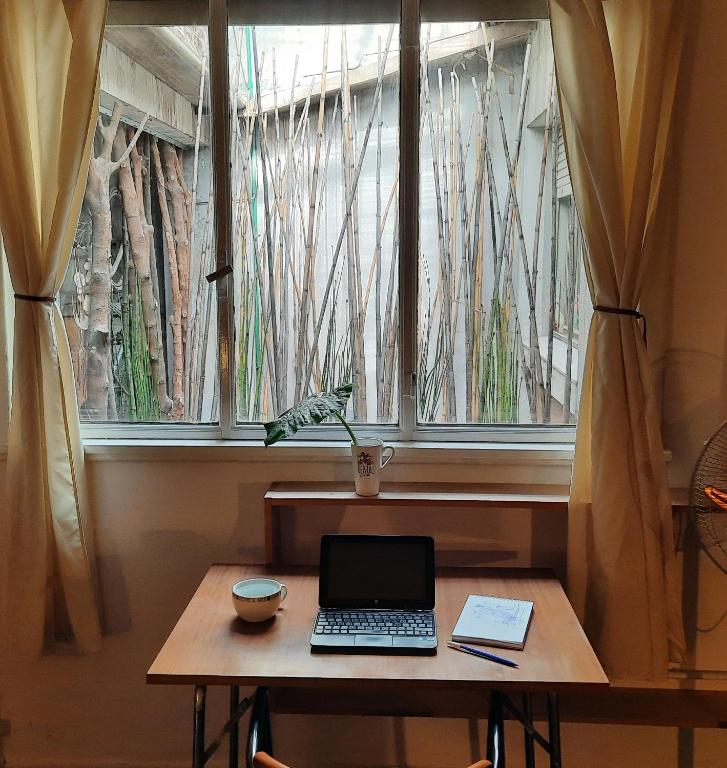 a laptop sitting on a table in front of a window at LodelaAbuela 3 in Ciudadela