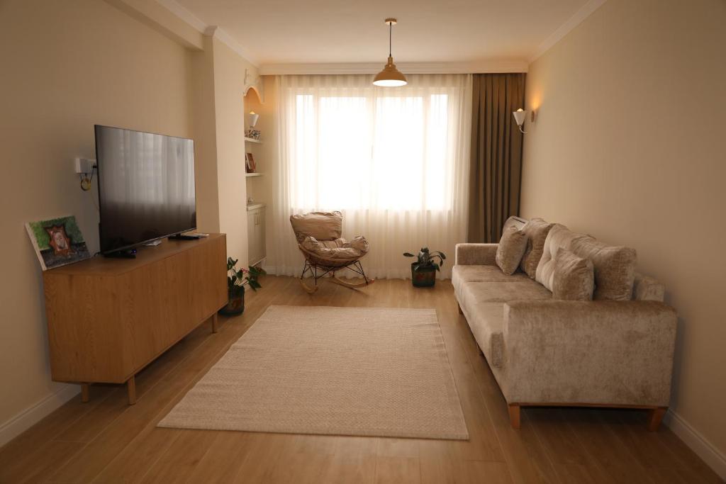 a living room with a couch and a flat screen tv at City Views Apartment in Shkodër